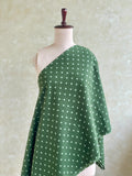 Forest green Jaipur cotton fabric featuring a polka dot pattern.