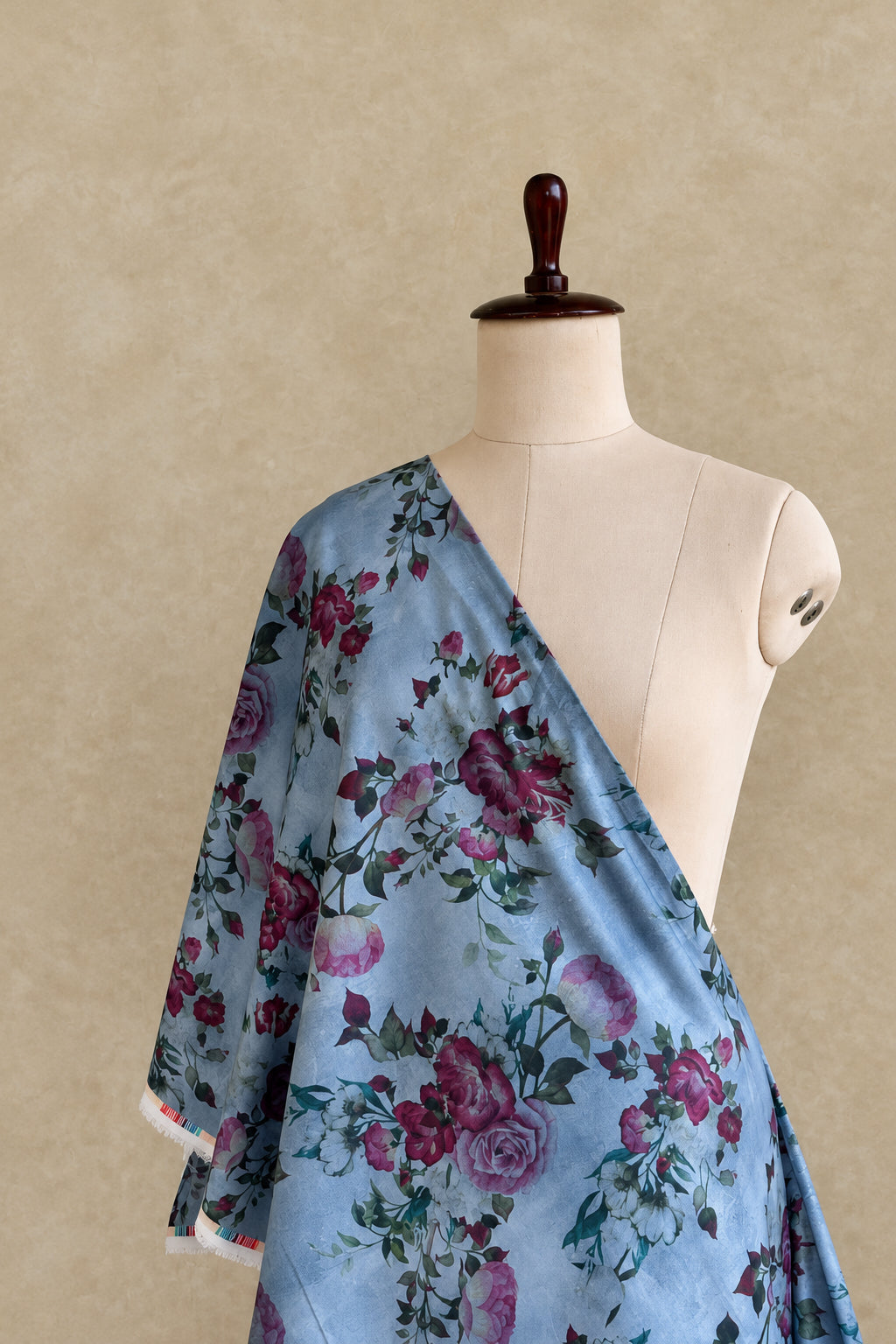 Slate blue Kapani cotton fabric featuring a floral print design.
