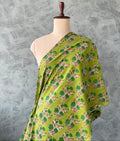 Fresh green Jaipur cotton fabric featuring pink floral prints.