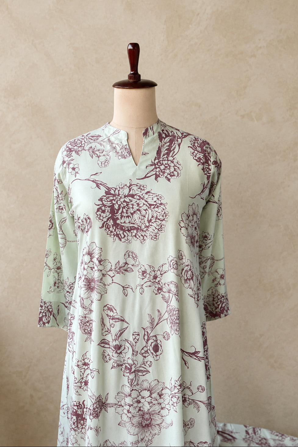A cream rayon floral printed co-ordset  a-line flared cut with chic v-notch collar 