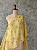 Pale yellow Banarasi silk Chanderi fabric featuring an elegant floral print.