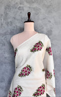 Ivory white Chanderi fabric with pink floral bouquets and olive green leafy motifs.